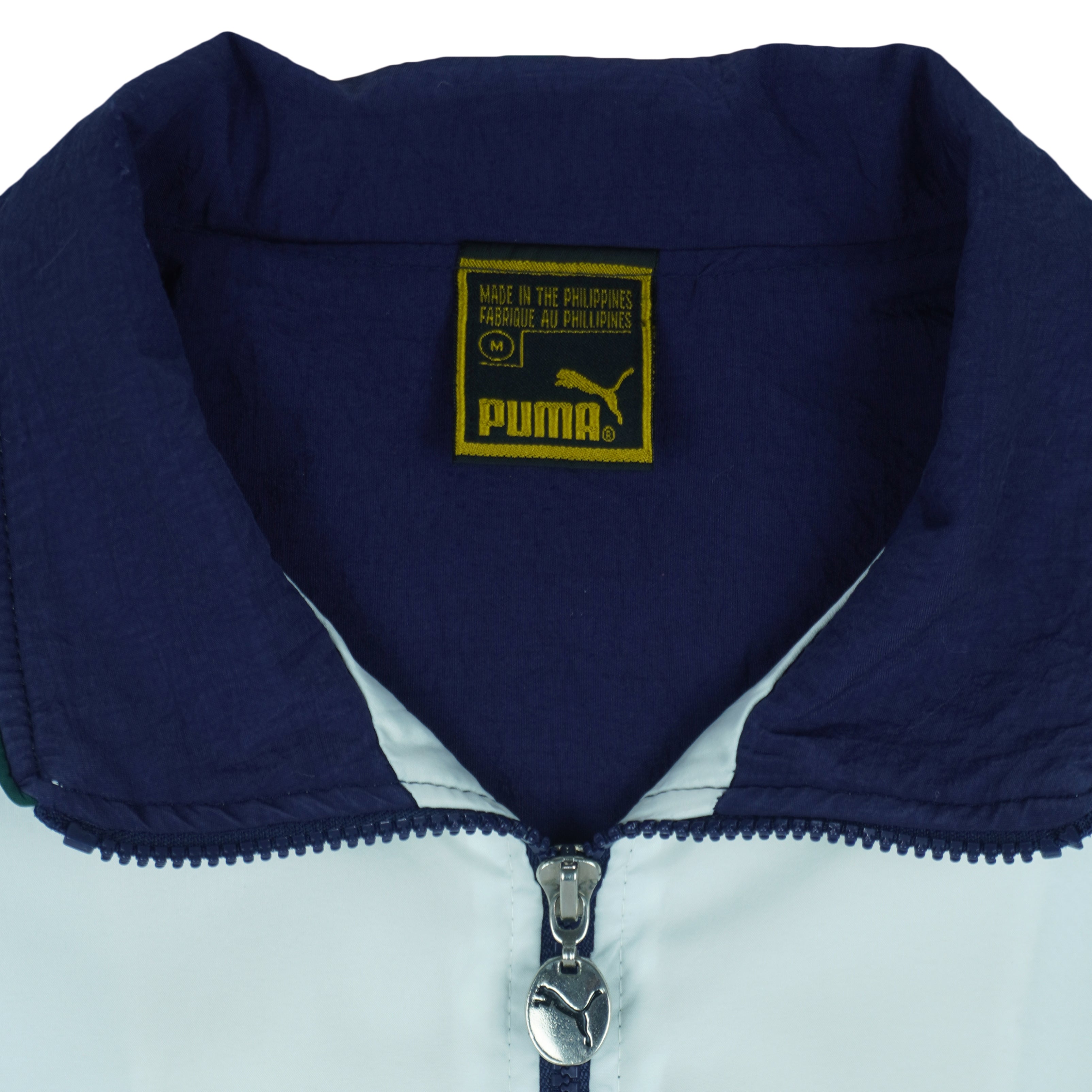 1990s vintage Puma colorblock taped logo windbreaker. Dark blue, green and white in color, fitting medium in size and in excellent condition.