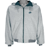 1990s vintage Nike reversible colorblock jacket-to-hoodie sweatshirt. Green and grey in color with large embroidered swoosh on windbreaker side, Medium in size and is in excellent condition.