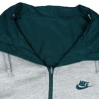 1990s vintage Nike reversible colorblock jacket-to-hoodie sweatshirt. Green and grey in color with large embroidered swoosh on windbreaker side, Medium in size and is in excellent condition.