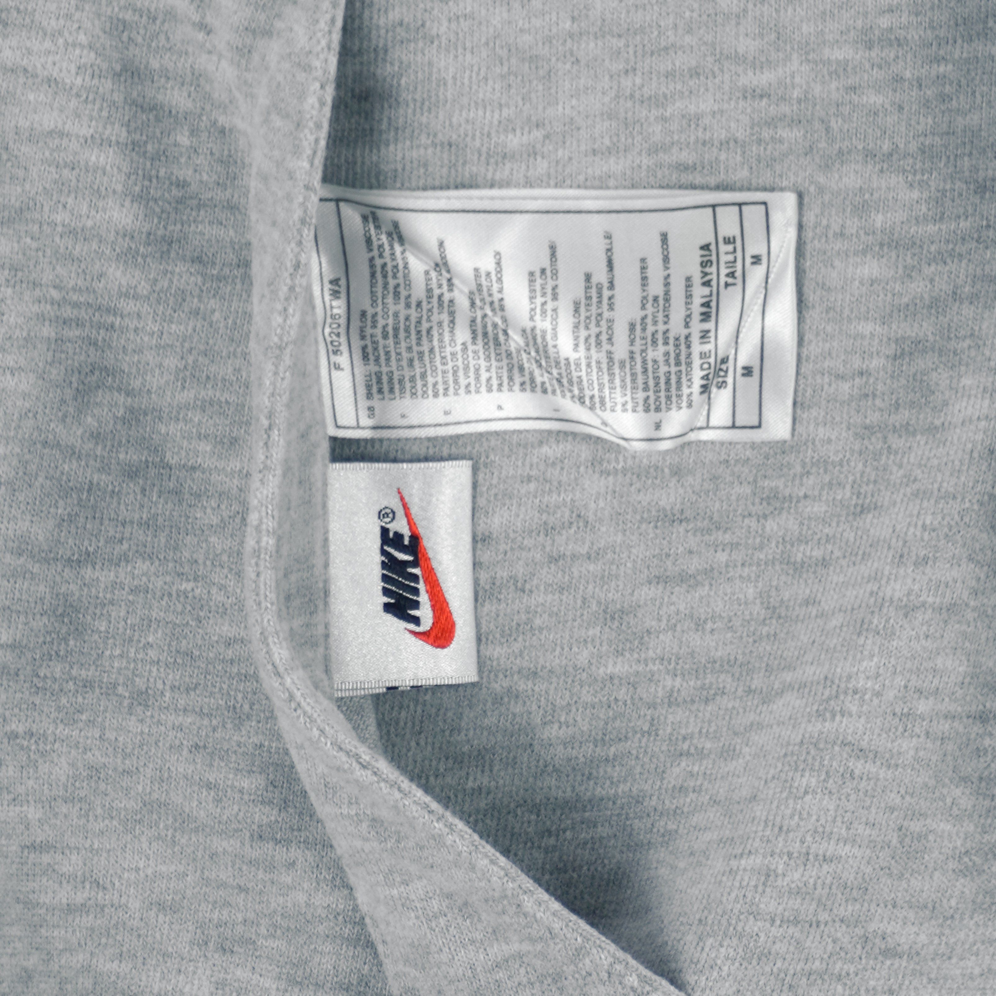 1990s vintage Nike reversible colorblock jacket-to-hoodie sweatshirt. Green and grey in color with large embroidered swoosh on windbreaker side, Medium in size and is in excellent condition.