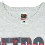 1990s vintage NHL Red Wings hockey puck T-Shirt by Fruit Of The Loom. Grey in color, with big spell-out, fits Large size and is in excellent condition