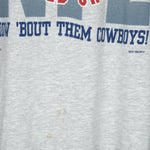 1993 vintage NFL Dallas Cowboys World champions spell-out T-Shirt. Grey in color with words "How 'Bout The Cowboys!" on front, Large in size and in very good condition.