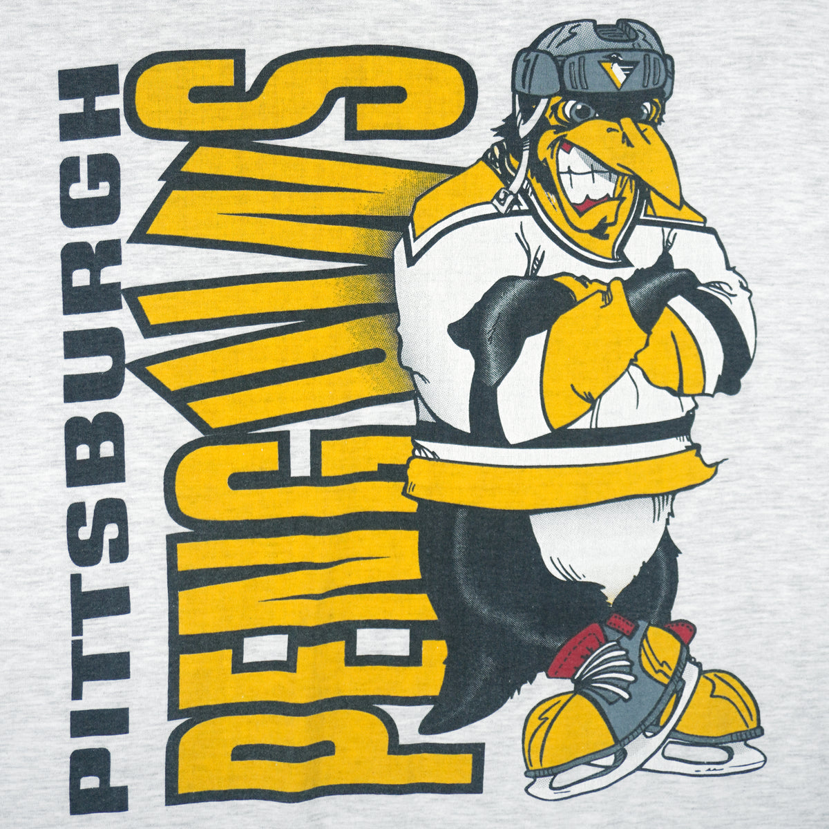 1990s vintage NHL Pittsburgh Penguins front and back printed T-Shirt. Grey in color with spell-out and cartoon penguin Iceburgh on front and back, fits X-Large in size and is in excellent condition.