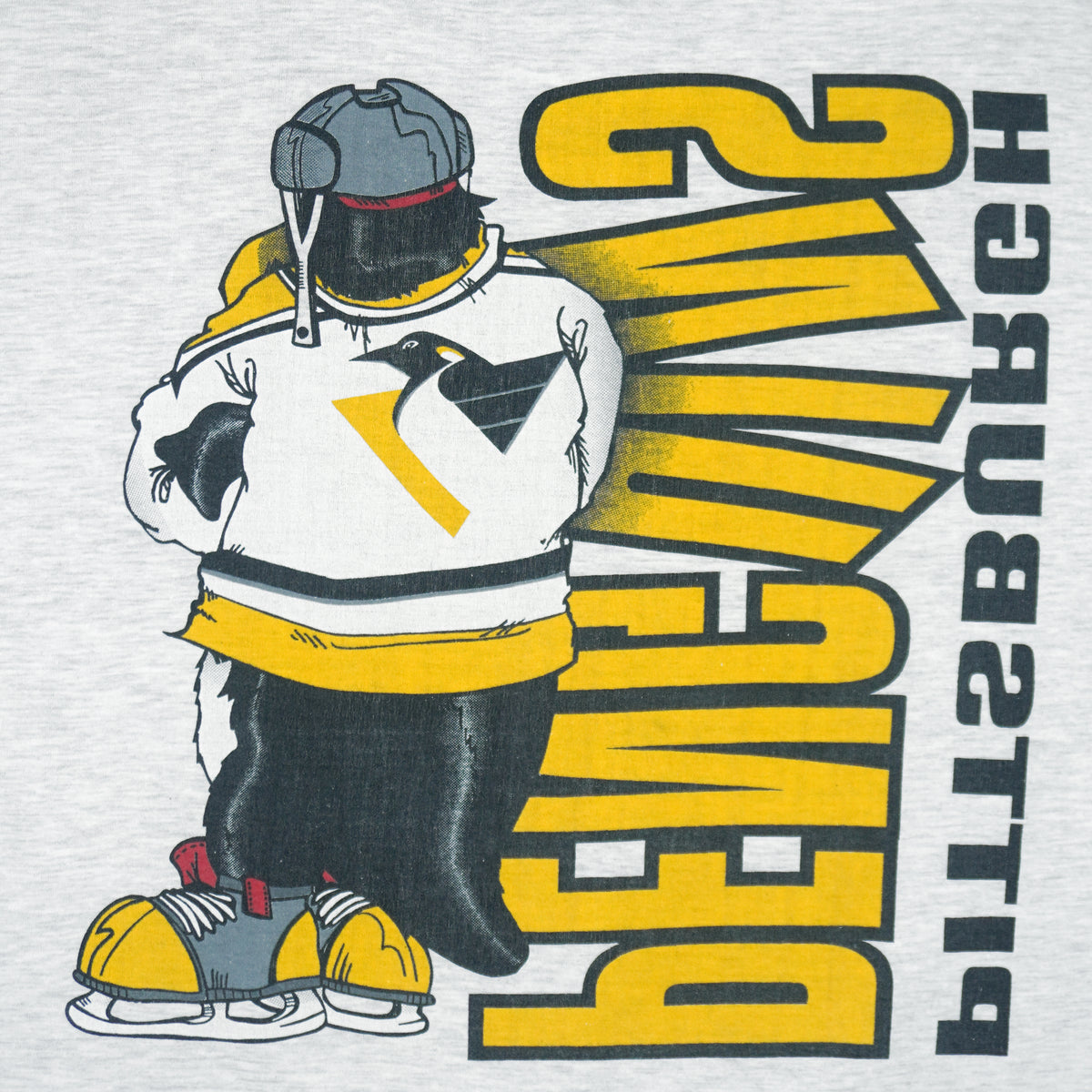 1990s vintage NHL Pittsburgh Penguins front and back printed T-Shirt. Grey in color with spell-out and cartoon penguin Iceburgh on front and back, fits X-Large in size and is in excellent condition.