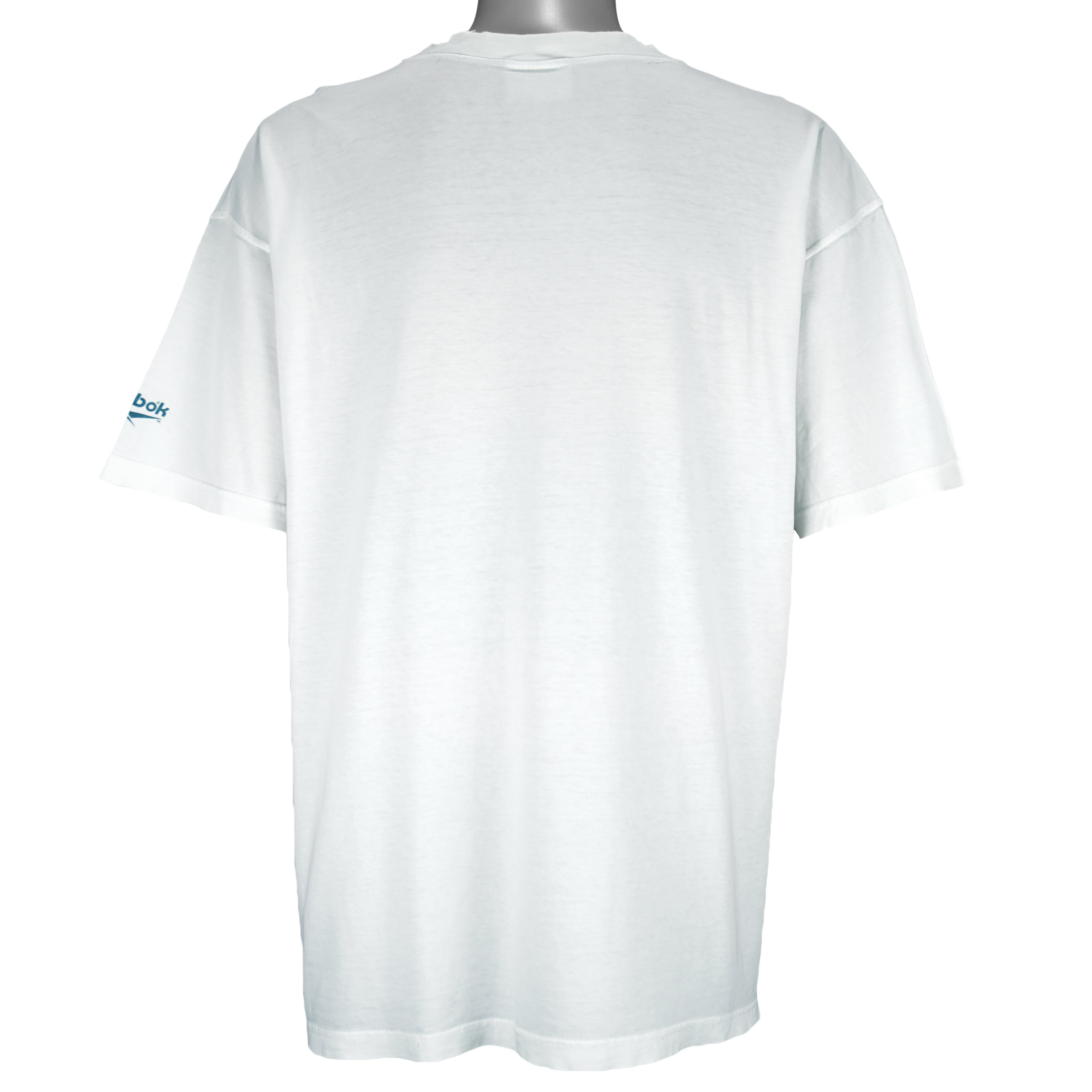 1994 vintage Reebok NFL Miami Dolphins spell-out T-Shirt. White in color with image of a football with teeth on front and Reebok logo on left sleeve, fits X-Large in size and is in excellent condition.
