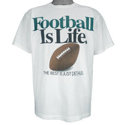 1992 vintage Big Ball Sports T-Shirt. White​ in color with spell-out "Football Is Life: The Rest is Just Details" on front and small brand logo on back, Large in size and in excellent condition.
