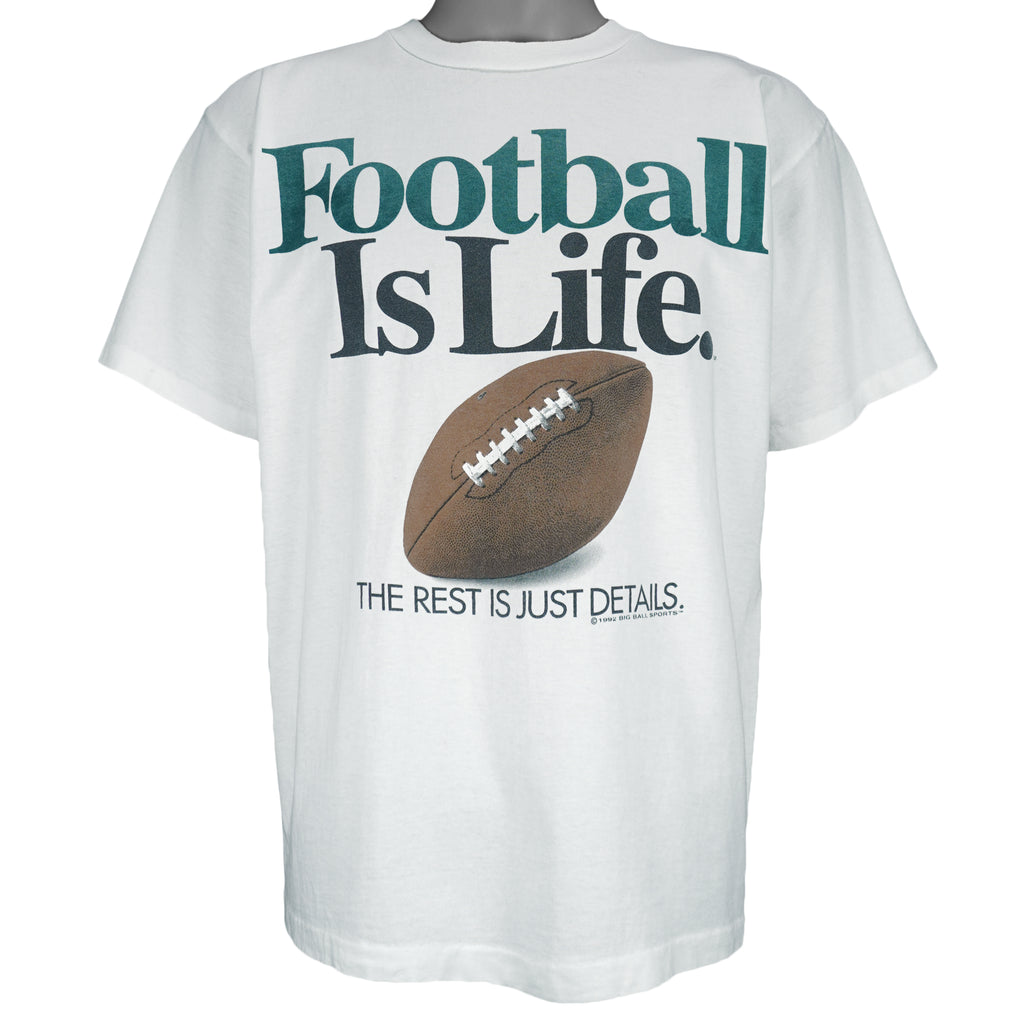 1992 vintage Big Ball Sports T-Shirt. White​ in color with spell-out "Football Is Life: The Rest is Just Details" on front and small brand logo on back, Large in size and in excellent condition.