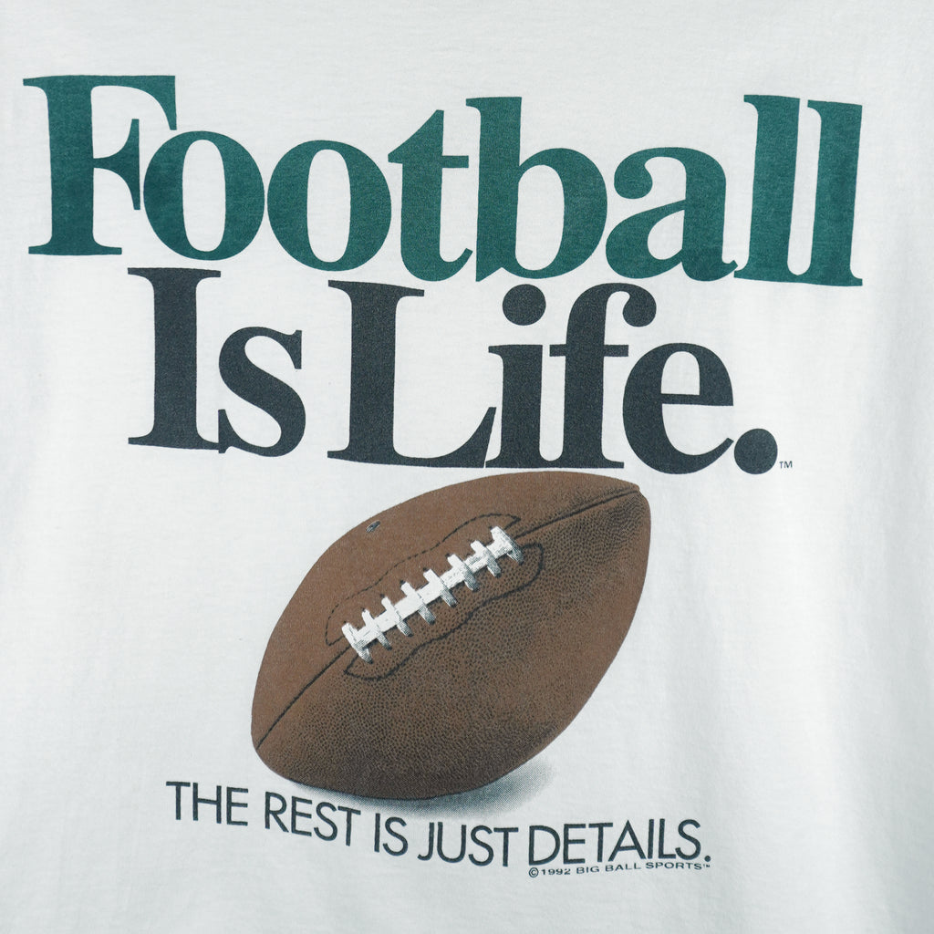 1992 vintage Big Ball Sports T-Shirt. White​ in color with spell-out "Football Is Life: The Rest is Just Details" on front and small brand logo on back, Large in size and in excellent condition.