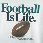 1992 vintage Big Ball Sports T-Shirt. White​ in color with spell-out "Football Is Life: The Rest is Just Details" on front and small brand logo on back, Large in size and in excellent condition.