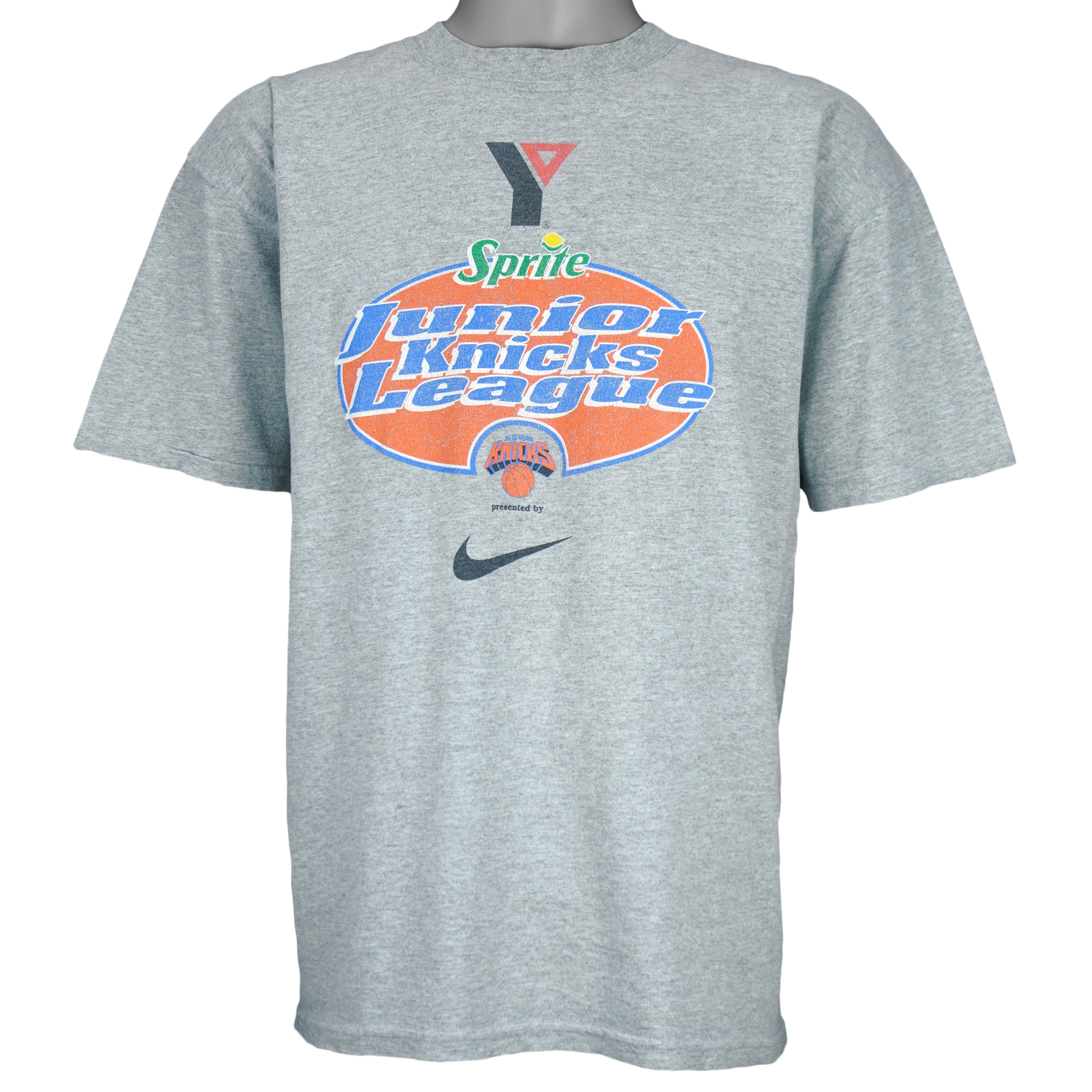 1990s vintage NBA New York Knicks Junior League T-Shirt from Jerzees. Grey in color with YMCA, Sprite, Knicks and Nike logos on front, Foot Locker logo on back, Large in size and is in excellent condition.