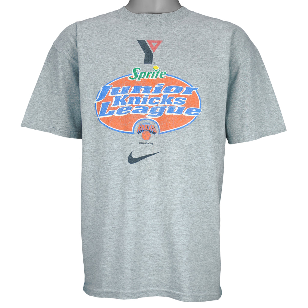 1990s vintage NBA New York Knicks Junior League T-Shirt from Jerzees. Grey in color with YMCA, Sprite, Knicks and Nike logos on front, Foot Locker logo on back, Large in size and is in excellent condition.