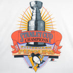 1991 vintage NHL Pittsburgh Penguins Stanley Cup Champions T-Shirt by Fruit of the Loom. White in color with large trophy print by Starter on front, fits a long Large in size and is in an excellent condition.