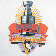 1991 vintage NHL Pittsburgh Penguins Stanley Cup Champions T-Shirt by Fruit of the Loom. White in color with large trophy print by Starter on front, fits a long Large in size and is in an excellent condition.