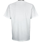 2003 vintage MLB Seattle Mariners "Road to the Show" spell-out T-Shirt by Gildan. White in color with farm team logos (Everett Aquasox, Wisconsin Timber Rattlers, Inland Empire 66ers of San Bernardino, San Antonio Missions, Tacoma Rainiers), Medium in size and is in excellent condition.