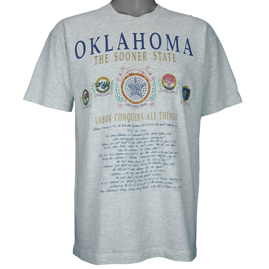 1990s vintage Oklahoma "The Sooner State" T-Shirt by Fruit of the Loom. Grey in color with various state facts and history printed on front, Large in size and is in excellent condition.