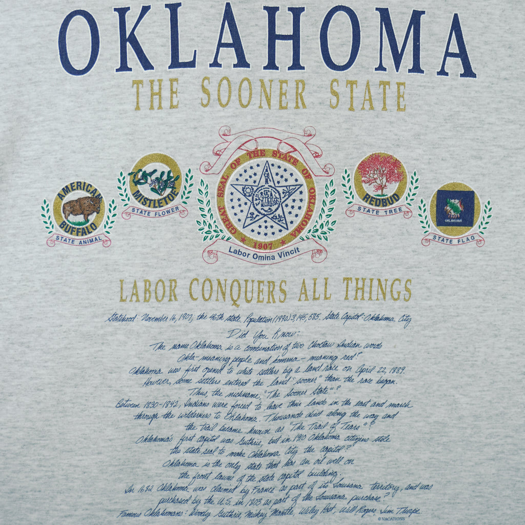 1990s vintage Oklahoma "The Sooner State" T-Shirt by Fruit of the Loom. Grey in color with various state facts and history printed on front, Large in size and is in excellent condition.