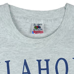 1990s vintage Oklahoma "The Sooner State" T-Shirt by Fruit of the Loom. Grey in color with various state facts and history printed on front, Large in size and is in excellent condition.
