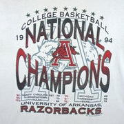 1994 vintage NCAA Arkansas Razorbacks National Champions T-Shirt by Jerzees. White in color with stats spell-out printed by Red Oak Sportswear, X-Large in size and is in excellent condition.