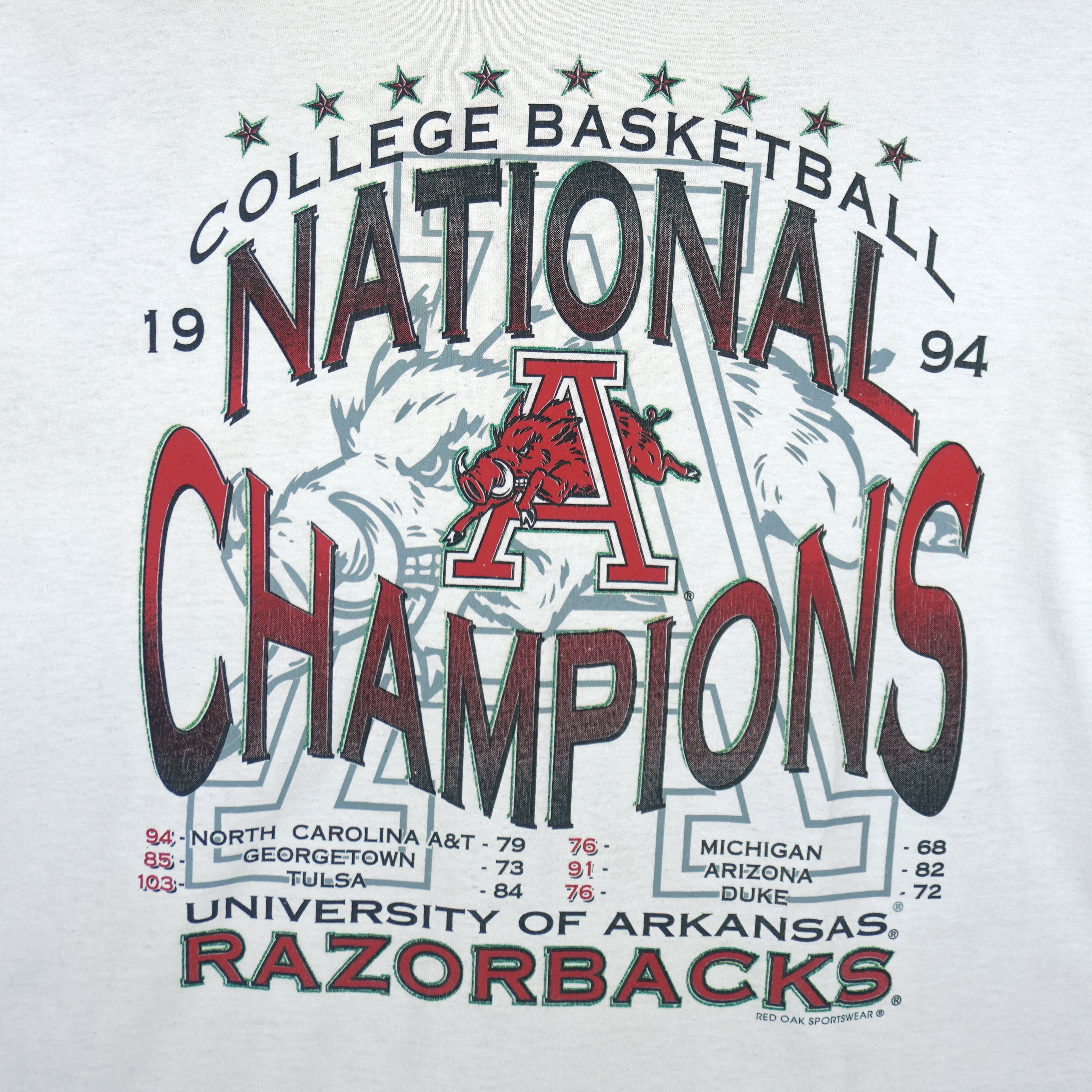 1994 vintage NCAA Arkansas Razorbacks National Champions T-Shirt by Jerzees. White in color with stats spell-out printed by Red Oak Sportswear, X-Large in size and is in excellent condition.