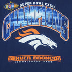 1998 vintage NFL Denver Broncos, Super Bowl XXXII Champions, T-Shirt by Lee. Blue​ in color with big spell-out and logo on front, tag is X-Large but fits Large in size and is in very good condition.