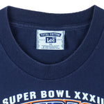 1998 vintage NFL Denver Broncos, Super Bowl XXXII Champions, T-Shirt by Lee. Blue​ in color with big spell-out and logo on front, tag is X-Large but fits Large in size and is in very good condition.