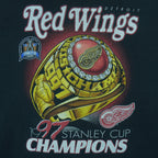 1997 vintage NHL Detroit Red Wings, Stanley Cup Champions Ring T-Shirt by Pro Player. Black in color with spell-out on front and brand emblem embroidered on left sleeve, X-Large size and is in excellent condition.