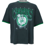 1990s vintage NBA Boston Celtics roll em ups, ringer, spell-out T-Shirt by Official Fan. Black in color with green trim, X-Large in size and is in excellent condition.