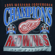 1995 vintage NHL Detroit Red Wings Western Conference Champions T-Shirt. Black in color with big spell-out and logo on front, fitting X-Large in size and is in excellent condition.