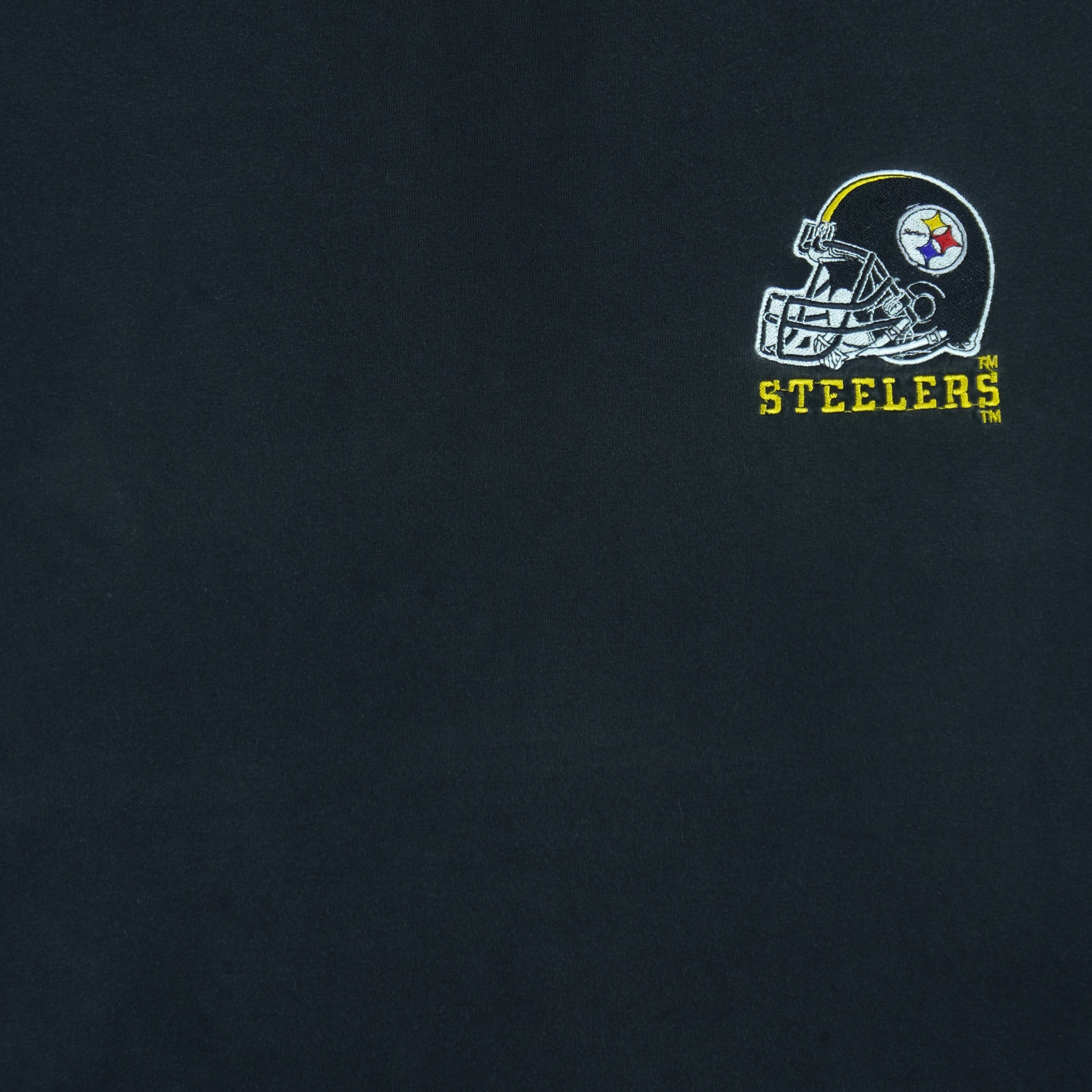 1990s vintage NFL Pittsburgh Steelers embroidered T-Shirt by Logo Athletic. Black in color with patch above right breast and on left sleeve, fits X-Large and is in excellent condition.