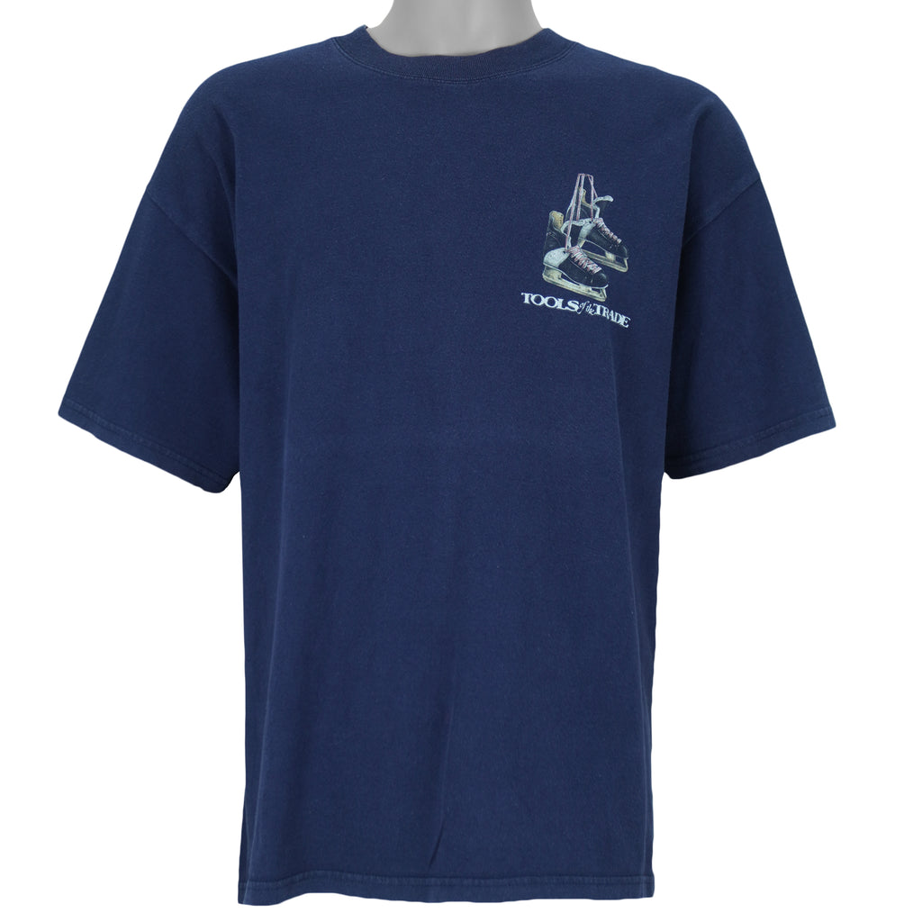 2001 vintage Tools of the Trade Hockey T-Shirt by Gildan. Blue in color with small image on front and large printed art on back by Jim Baldwin, fits X-Large in size and is in excellent condition.