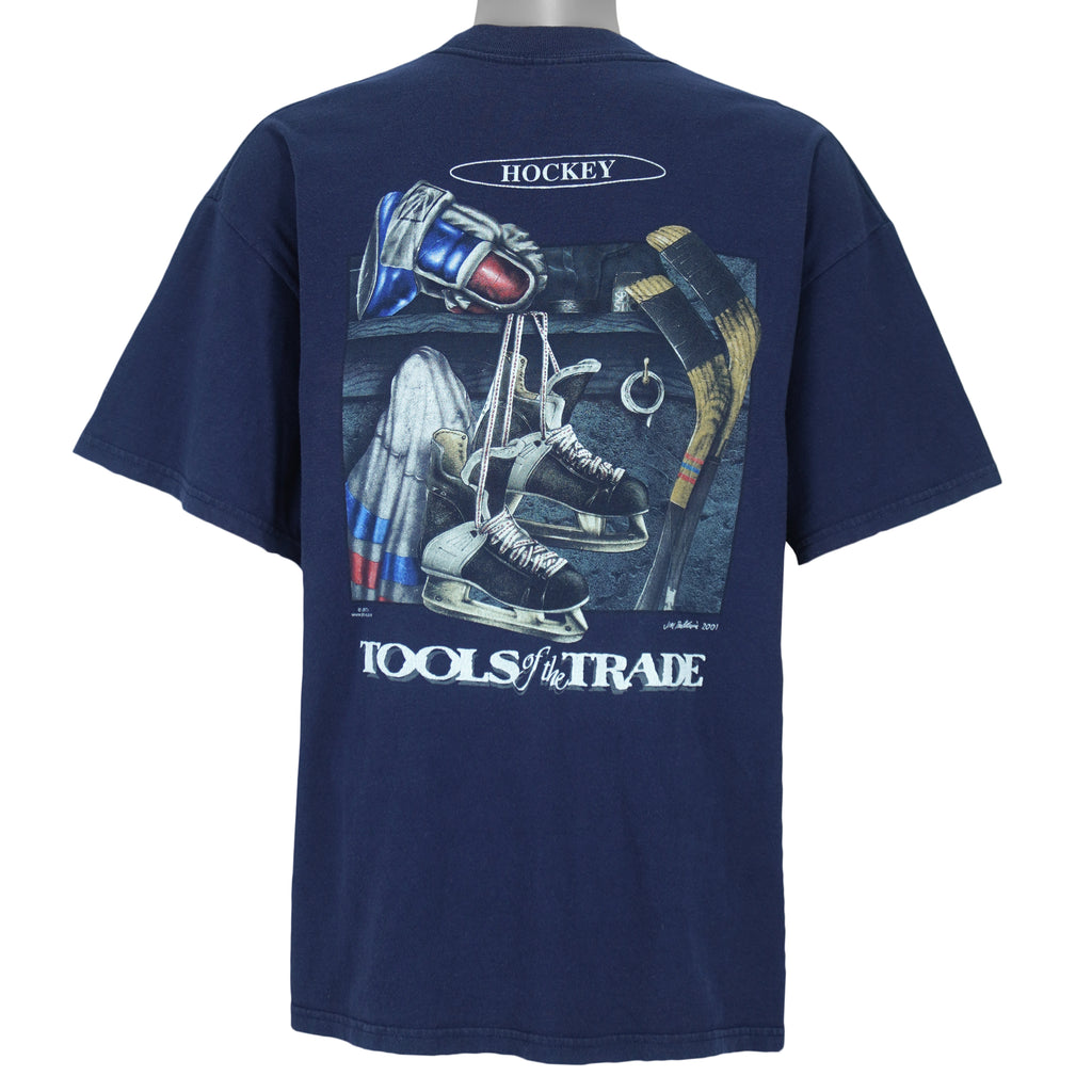 2001 vintage Tools of the Trade Hockey T-Shirt by Gildan. Blue in color with small image on front and large printed art on back by Jim Baldwin, fits X-Large in size and is in excellent condition.
