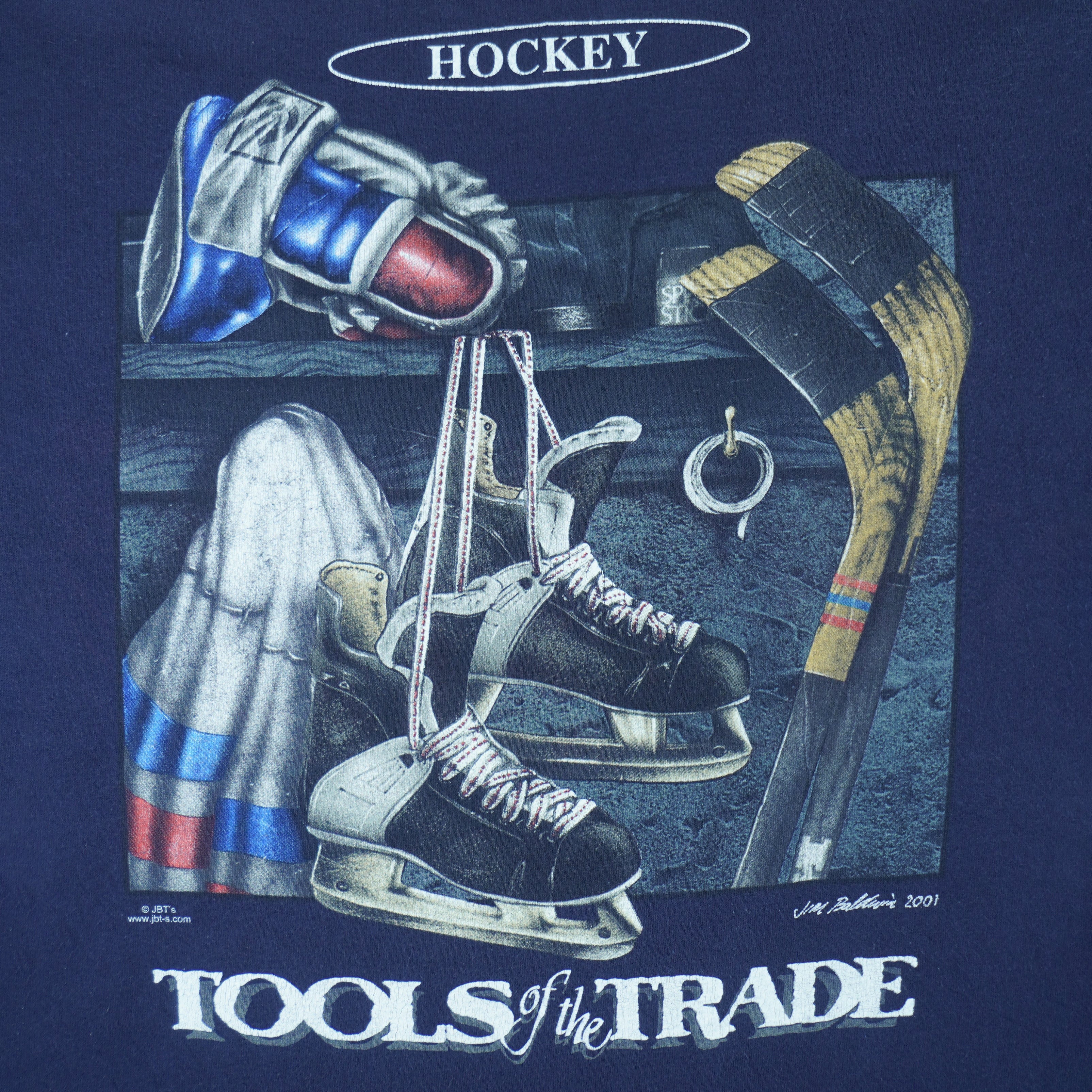 2001 vintage Tools of the Trade Hockey T-Shirt by Gildan. Blue in color with small image on front and large printed art on back by Jim Baldwin, fits X-Large in size and is in excellent condition.