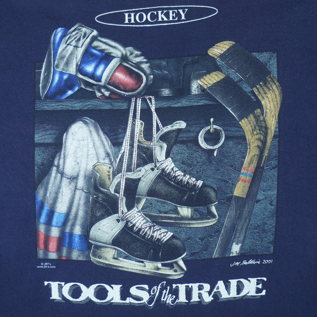 2001 vintage Tools of the Trade Hockey T-Shirt by Gildan. Blue in color with small image on front and large printed art on back by Jim Baldwin, fits X-Large in size and is in excellent condition.