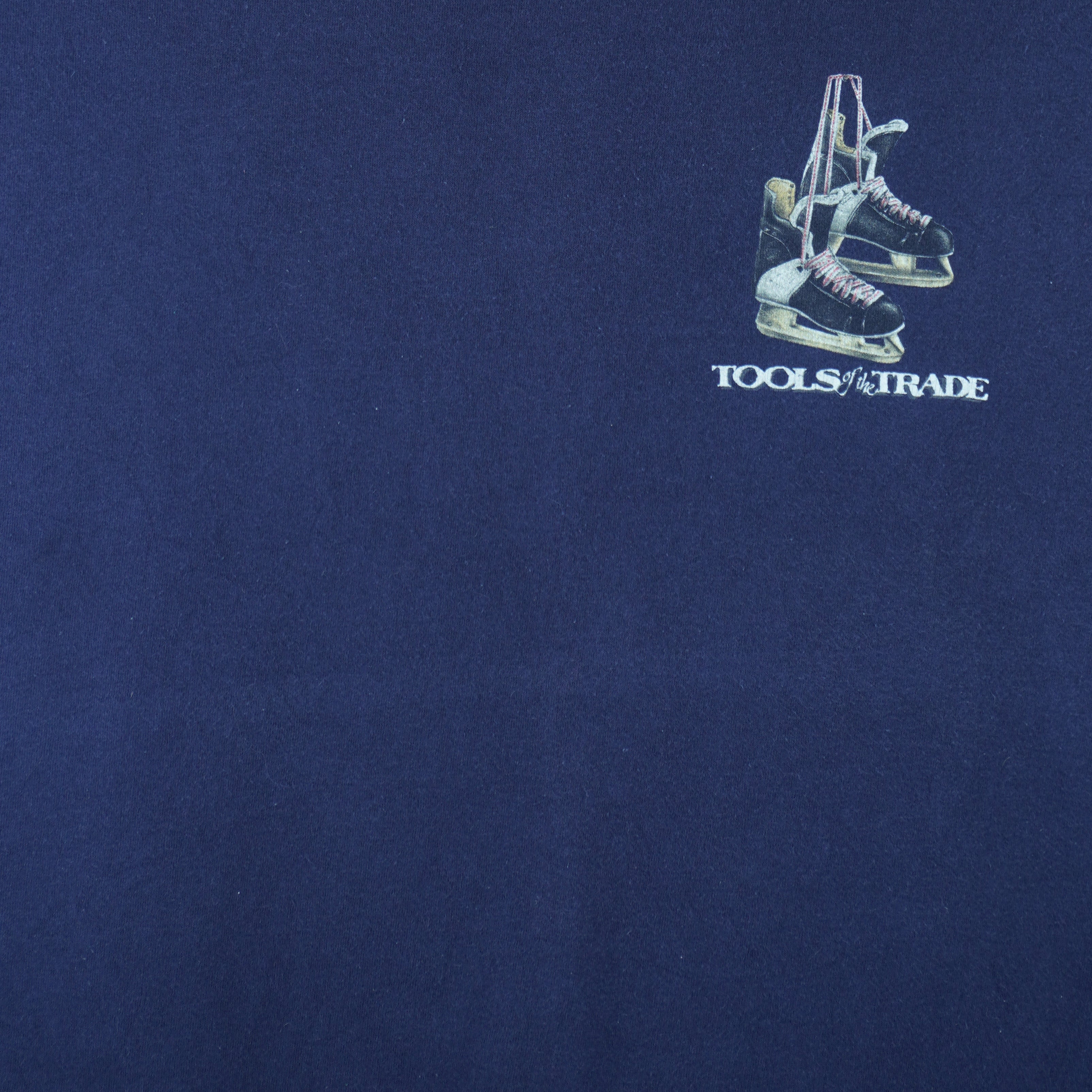 2001 vintage Tools of the Trade Hockey T-Shirt by Gildan. Blue in color with small image on front and large printed art on back by Jim Baldwin, fits X-Large in size and is in excellent condition.