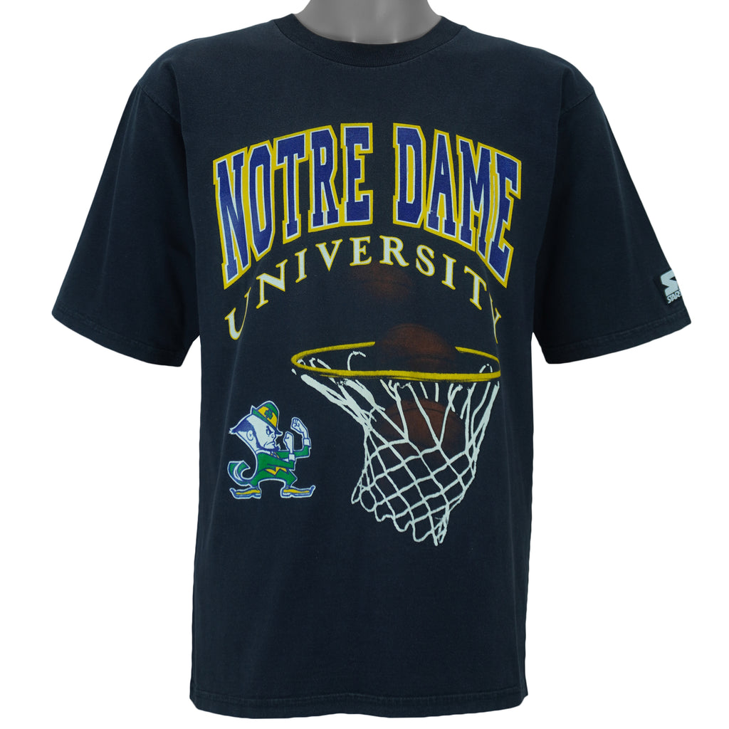 1990s vintage NCAA Notre Dame Fighting Irish basketball swish T-Shirt by Starter. Dark in color, fits Medium in size and is excellent condition.