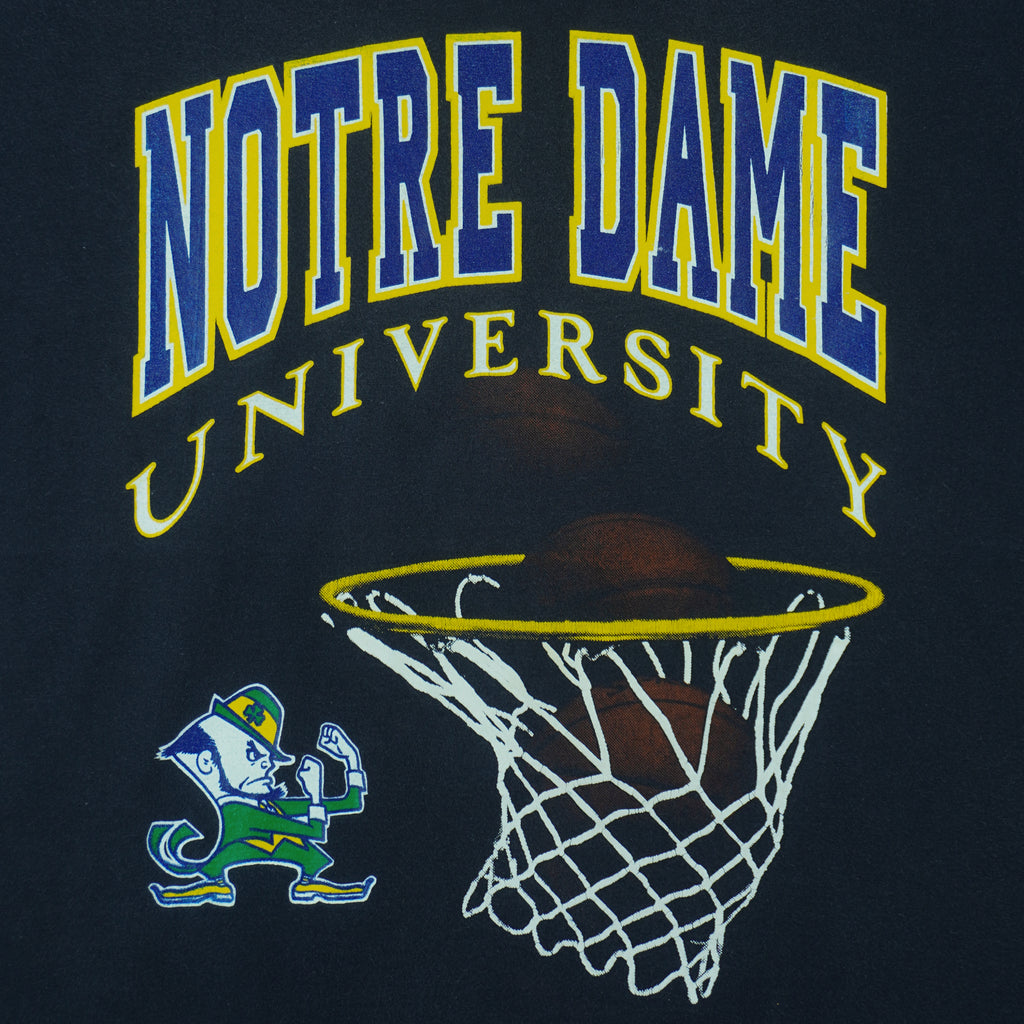 1990s vintage NCAA Notre Dame Fighting Irish basketball swish T-Shirt by Starter. Dark in color, fits Medium in size and is excellent condition.