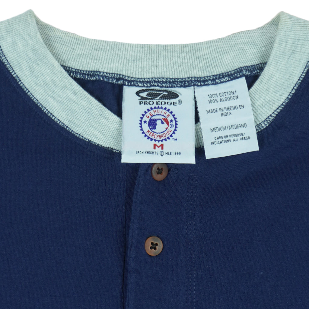 1999 vintage MLB New York Yankees embroidered T-Shirt by Pro Edge, Genuine Merchandise. Blue in color with three buttons at collar and grey trim, fits Medium to Large in size and is in excellent condition.