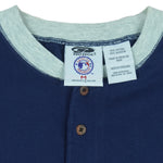 1999 vintage MLB New York Yankees embroidered T-Shirt by Pro Edge, Genuine Merchandise. Blue in color with three buttons at collar and grey trim, fits Medium to Large in size and is in excellent condition.