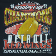 1998 vintage NHL Detroit Red Wings Stanley Cup Champions 97-98 T-Shirt by Logo 7. Black in color with big printed graphic and spell-out on front: Cup 2 Cup, Nine for All Time. Large in size and is in excellent condition.