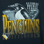 1993 vintage NHL Pittsburgh Penguins T-Shirt by Logo Athletic. Black in color with big spell-out and big chrome-style logo graphic on front, Large in size and is in excellent condition.