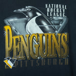 1993 vintage NHL Pittsburgh Penguins T-Shirt by Logo Athletic. Black in color with big spell-out and big chrome-style logo graphic on front, Large in size and is in excellent condition.