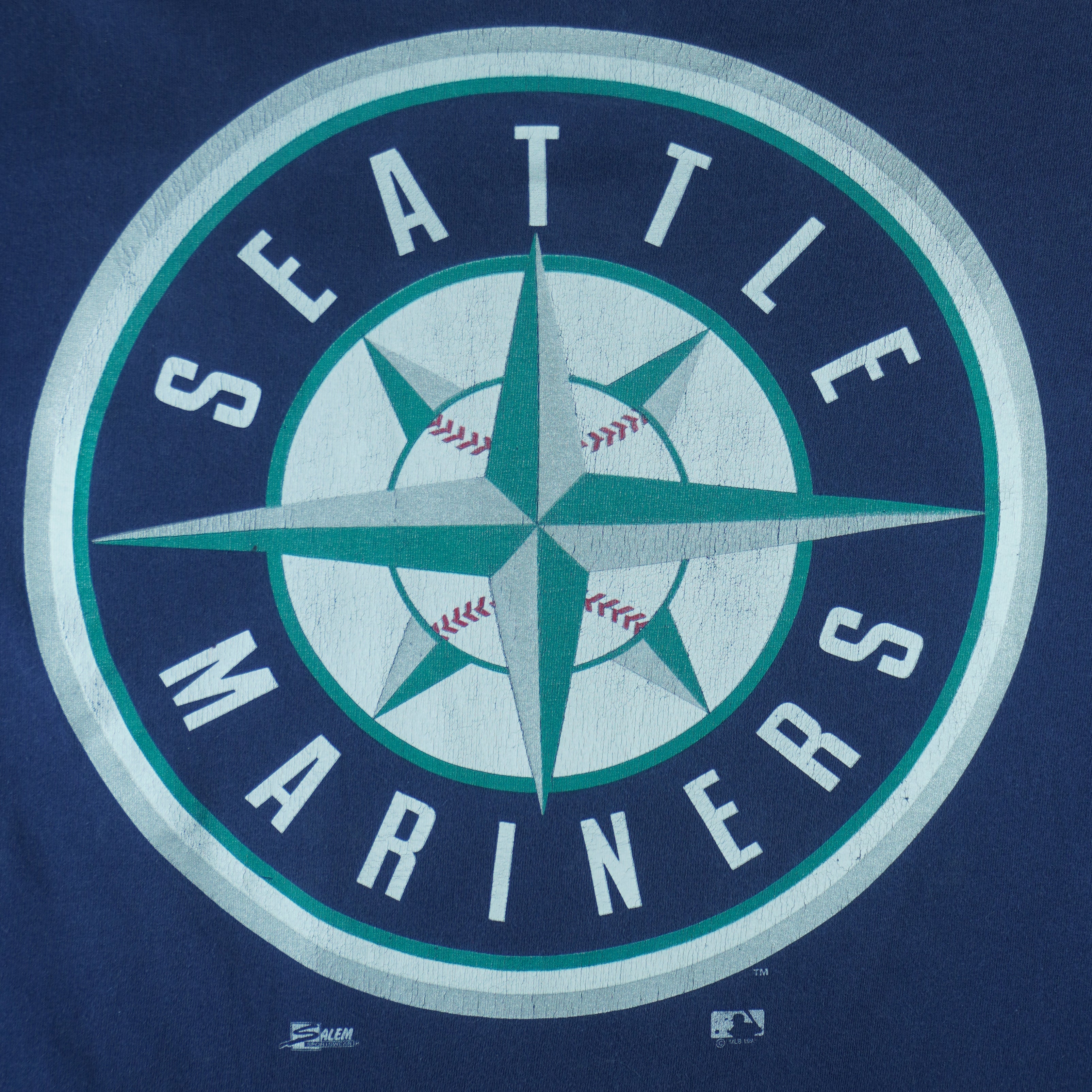 1998 or 99 vintage MLB Seattle Mariners T-Shirt by Salem Sportswear. Dark blue in color with big spell-out on front, big logo on back and small logo on left sleeve, X-Large in size and is in excellent condition.