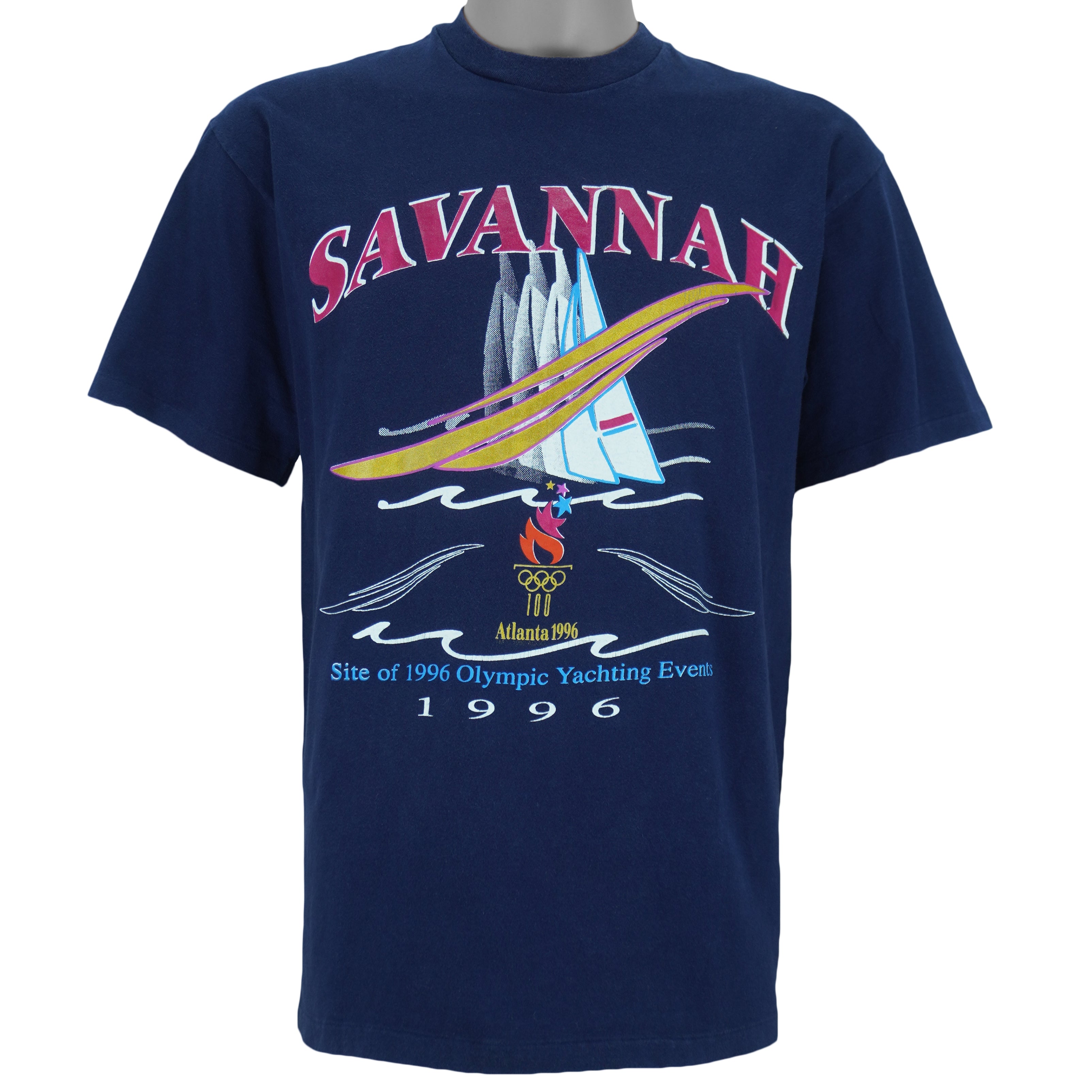 1996 vintage Atlanta Olympic Games Yachting T-Shirt by Hanes. Blue in color with "Site of 1996 Olympic Yachting Events" and "Savannah" spell-outs, Large in size and is in excellent condition.