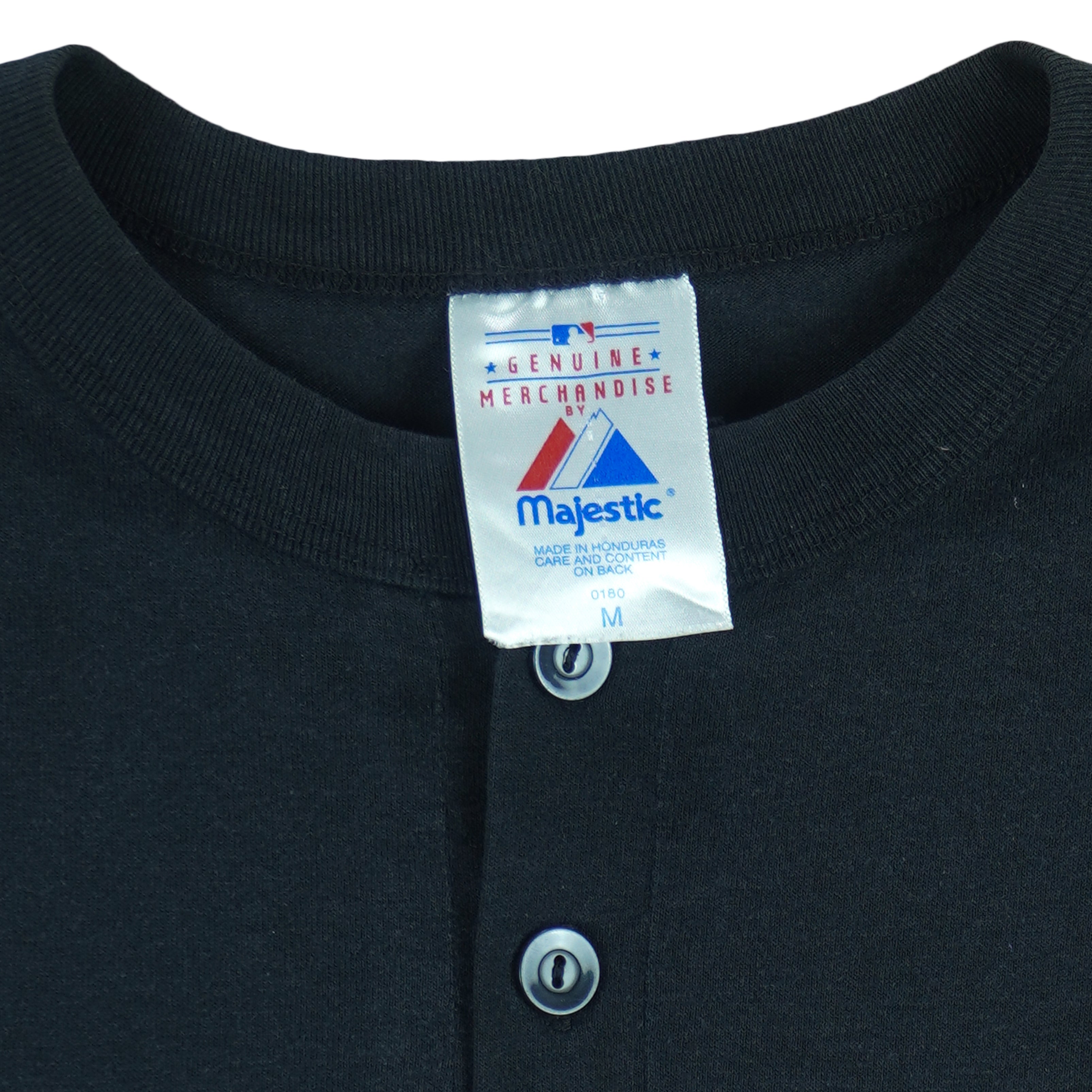 1990s vintage MLB Chicago White Sox button-collar T-Shirt by Majestic - Genuine Merchandise. Black in color with big logo on front, #10 on back, Majestic logo on right sleeve and Qdoba Mexican Grill logo on left sleeve, medium in size and is in very good condition.