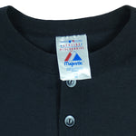 1990s vintage MLB Chicago White Sox button-collar T-Shirt by Majestic - Genuine Merchandise. Black in color with big logo on front, #10 on back, Majestic logo on right sleeve and Qdoba Mexican Grill logo on left sleeve, medium in size and is in very good condition.