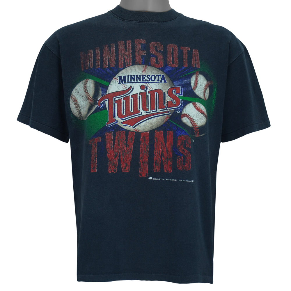 1991 vintage MLB Minnesota Twins spell-out T-Shirt by Bulletin Athletic. Blue in color with grunge lettering and baseball print on front, Medium in size and is in excellent condition.
