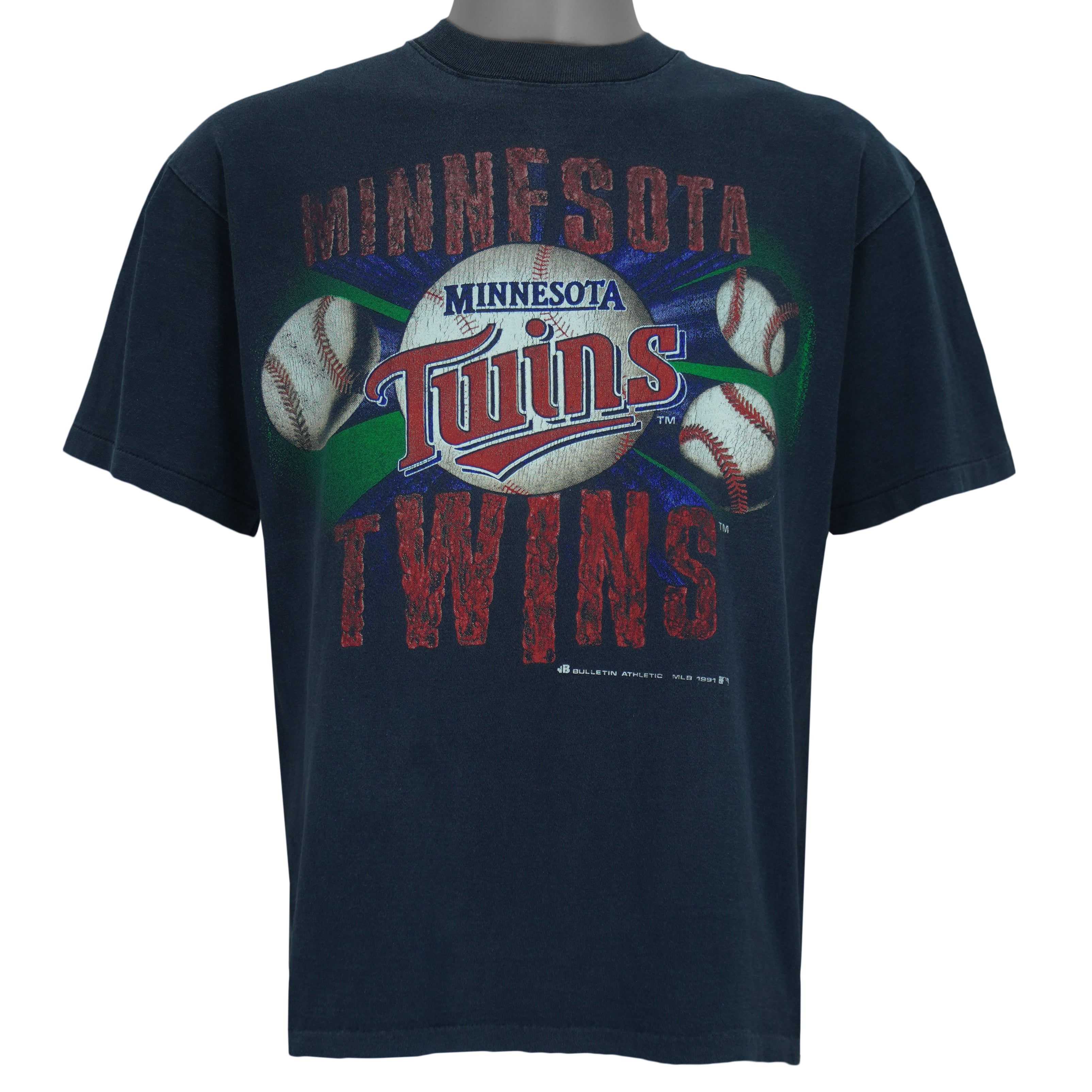 1991 vintage MLB Minnesota Twins spell-out T-Shirt by Bulletin Athletic. Blue in color with grunge lettering and baseball print on front, Medium in size and is in excellent condition.