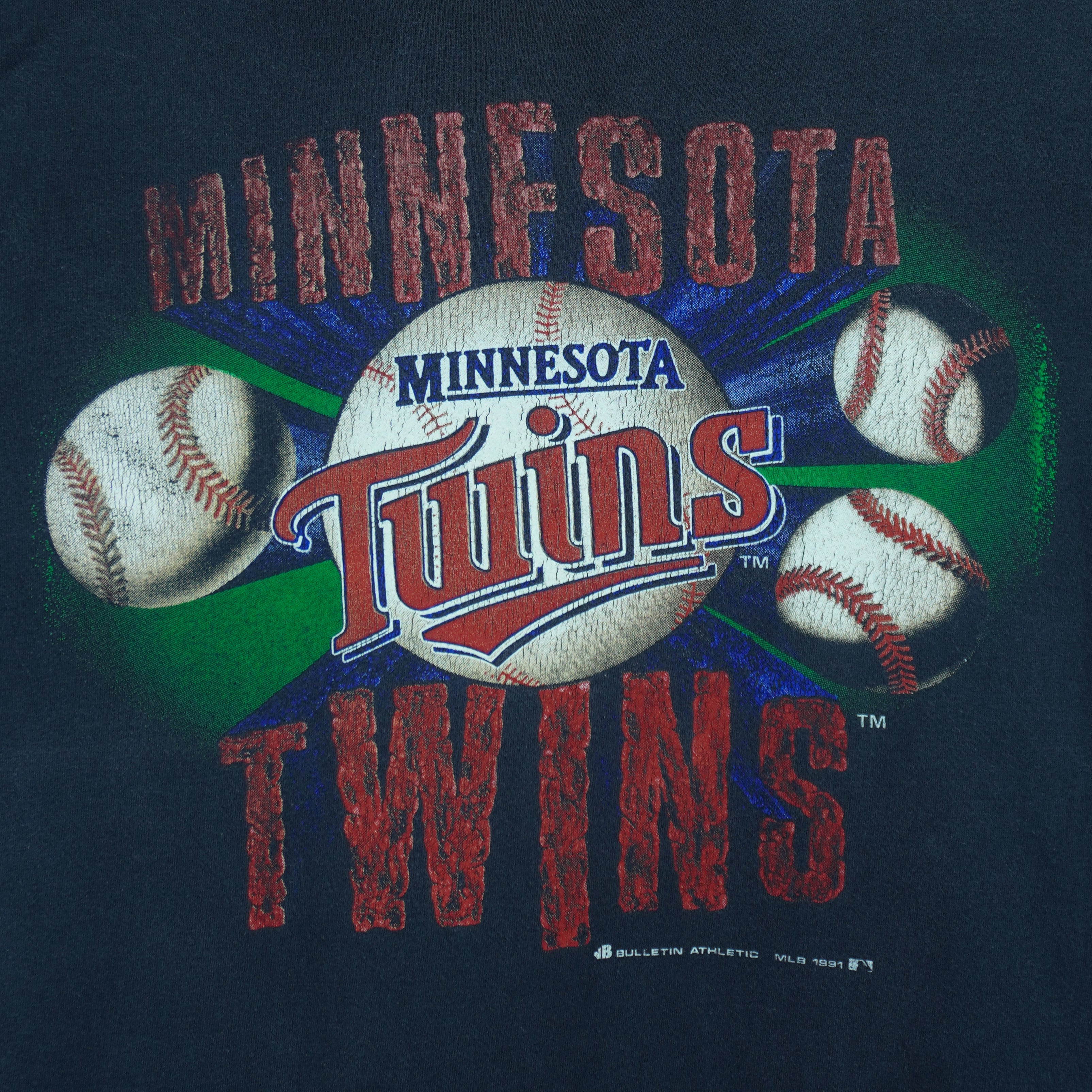 1991 vintage MLB Minnesota Twins spell-out T-Shirt by Bulletin Athletic. Blue in color with grunge lettering and baseball print on front, Medium in size and is in excellent condition.