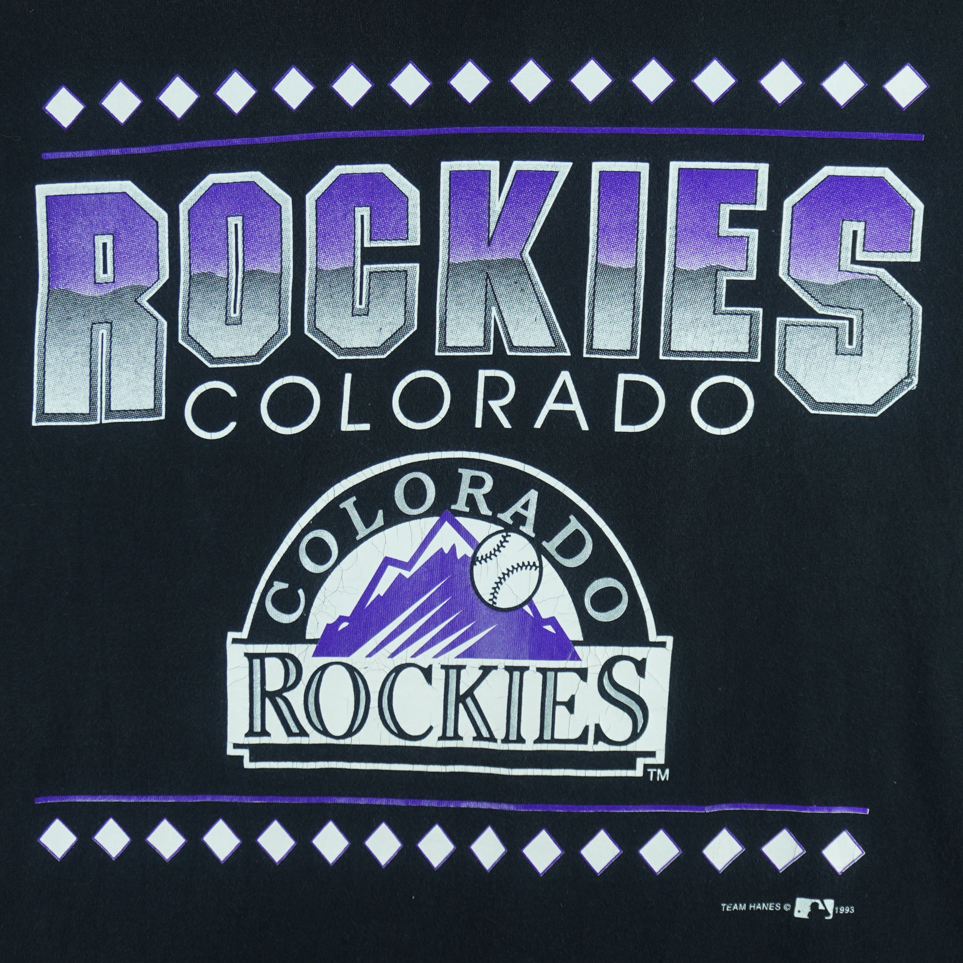 1993 vintage MLB Colorado Rockies T-shirt by Team Hanes. Black in color with big spell-out and logo on front, Medium in size and is in excellent condition.
