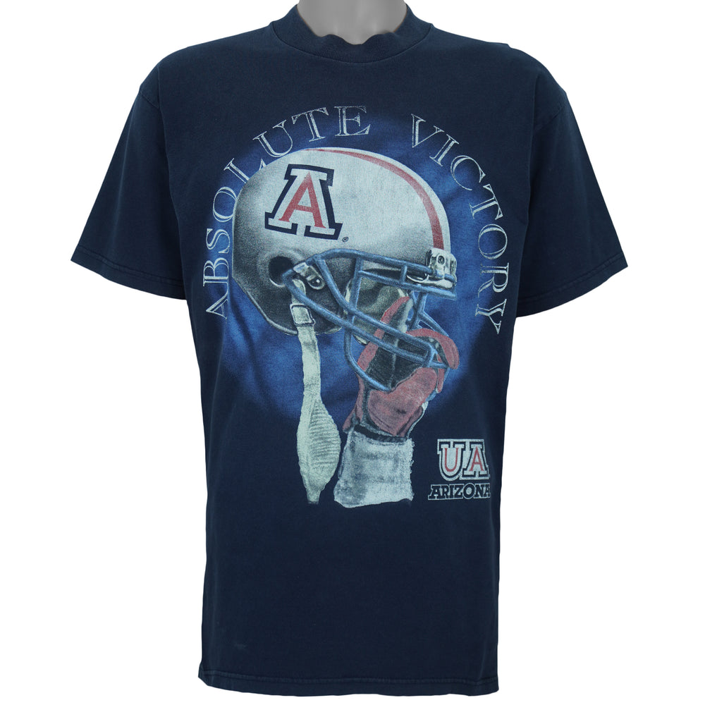 2000s vintage NCAA University of Arizona Wildcats football helmet T-Shirt. Dark blue in color with "Absolute Victory" spell-out on front and "We Came, We Saw, We Kicked Butt" on back. Fits Medium in size and in excellent condition.
